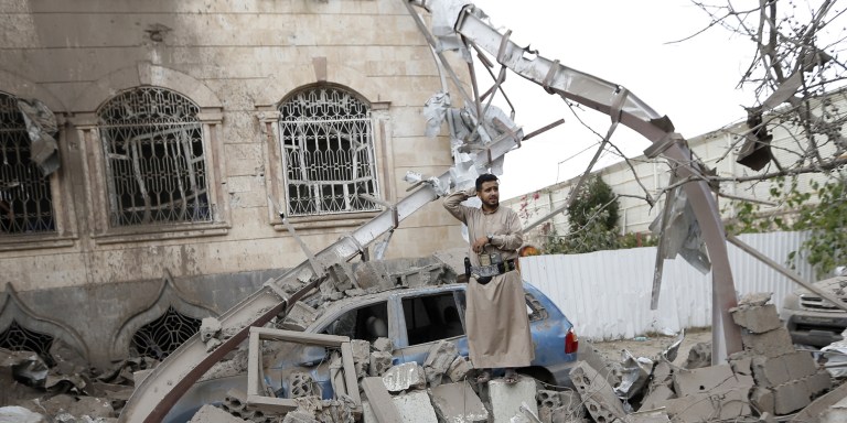 TOPSHOT - Yemenis stand on the rubble of houses destroyed in a suspected Saudi-led coalition air strike in Sanaa on June 9, 2017.Four civilians, including two teenagers, died "in a strike by the coalition that targeted a civilian house behind the presidential palace in the south of the capital", a medical source said. / AFP PHOTO / Mohammed HUWAIS (Photo credit should read MOHAMMED HUWAIS/AFP/Getty Images)