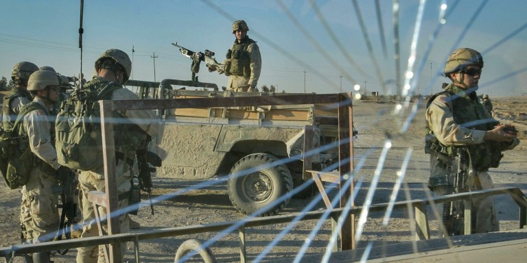 U.S. soldiers with the 82nd Airborne Division patrol at a coaltion checkpoint in Fallujah, Iraq, Nov. 20, 2003.
