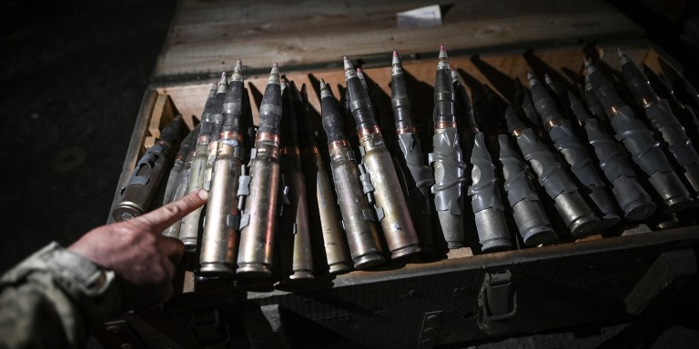 A Ukrainian servicemember points towards 30mm incendiary ammunition inside a storage warehouse, in the Donetsk Region of Ukraine on May 22, 2023. Ukrainian military mechanics and armored vehicle crew members of the 214th Separate Special Battalion conduct field tests and repair operations on damaged and captured vehicles following the battalion's combat missions in city of Bakhmut. (Photo by Justin Yau/ Sipa USA)(Sipa via AP Images)