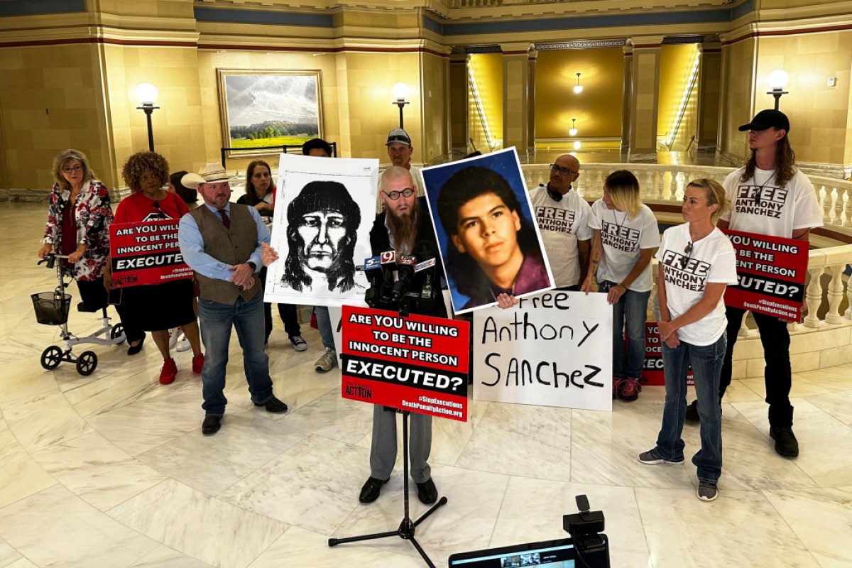 The Rev. Jeff Hood and supporters of Oklahoma death row inmate Anthony Sanchez proclaim his innocence during a news conference at the Oklahoma Capitol in Oklahoma City, May 25, 2023. Sanchez said Thursday, June 22, in a phone interview from death row that he plans to reject his opportunity for a clemency hearing in the case. (AP Photo/Sean Murphy)