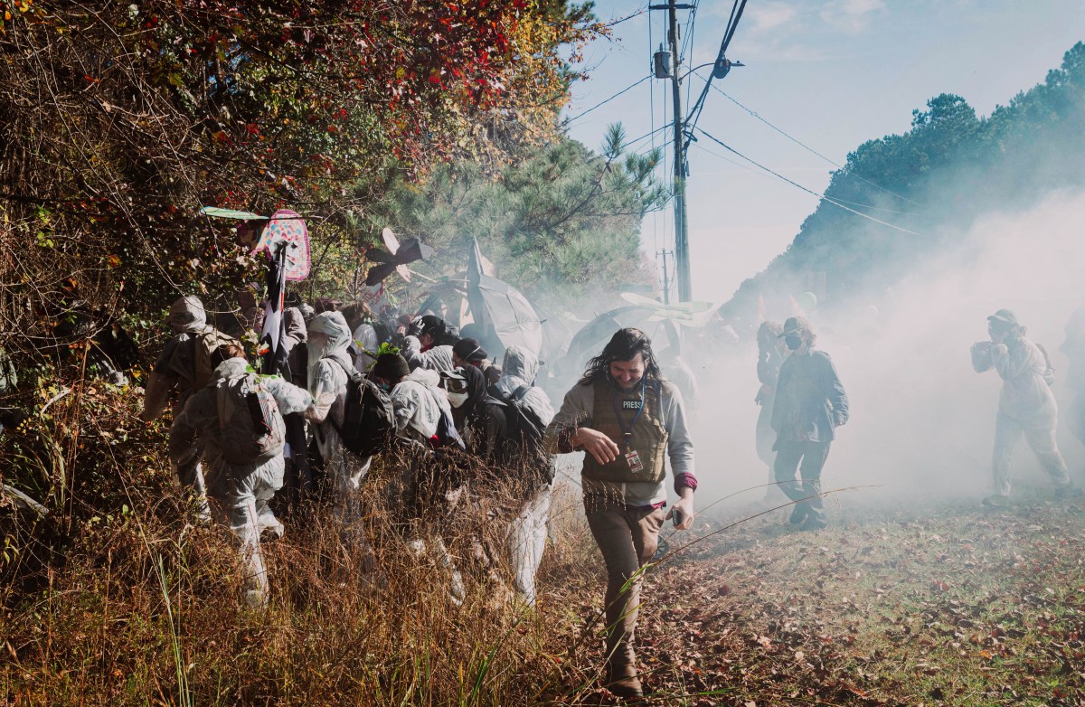 Journalist Matt Scott with the Atlanta Community Press Collective moves away from a cloud of tear gas thrown by Georgia law enforcement in Atlanta, Georgia on Monday, Nov. 13, 2023. 'Stop Cop City' activists gathered from across the United States to attend the 'Block Cop City' march to the construction site for the Atlanta Public Safety Training Center. (Photo by Carlos Berrios Polanco/Sipa USA)(Sipa via AP Images)