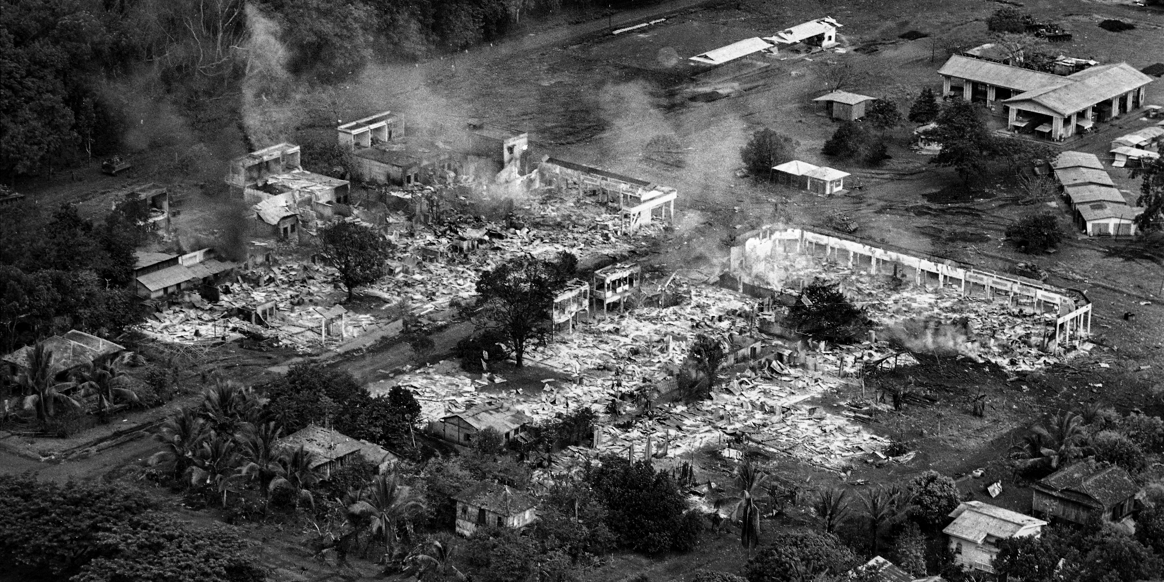 A section of the rubber plantation town of Snoul, Cambodia, smolders in early May 1970, after nearly 90 percent of the town was destroyed in air strikes and heavy fighting between U.S. forces and North Vietnamese troops. By May 6, the U.S. 11th Armored Cavalry Regiment occupied the town. (AP Photo/Henri Huet)