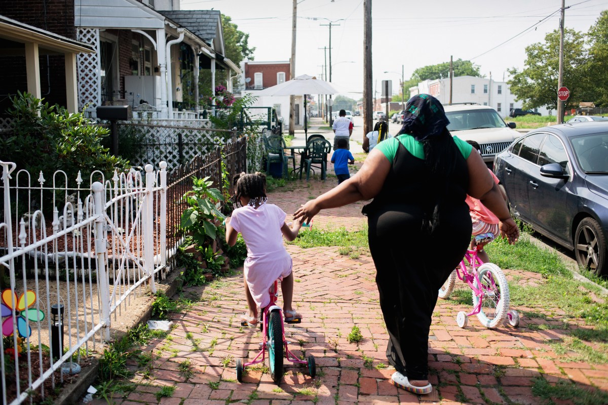 A mother of five walks with her children near the Covanta incineration facility in Chester, PA on June 28, 2023. All of her children have asthma but their conditions worsened since moving from one area of Chester to this block a few years ago. Emily Whitney for The Intercept