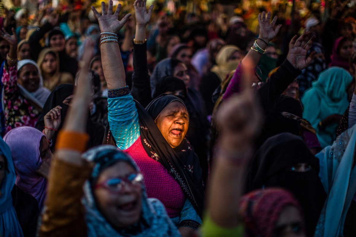 NEW DELHI, INDIA - FEBRUARY 22: Indian Muslim women protesters shout anti government slogans as they take part in a protest demonstration at the protest site at Shaheen Bagh area  on February 22, 2020in Shaheen Bagh area of Delhi, India. The Muslim-majority locality in Indias national capital has been in the spotlight for over past two months as hundreds of women have blocked a road over the controversial Citizenship Amendment Act (CAA), which triggered protests across India over fears that the law combined with the proposed National Register of Citizens (NRC) will be used by the Hindu nationalist Bharatiya Janata Party (BJP) government to strip Indian Muslims of citizenship. On Saturday, the protestors vacated a stretch of the road after a Supreme Court-appointed interlocutor visited the protest site and assured to place their demands before Indias apex court, Indian media reported. (Photo by Yawar Nazir/ Getty Images)