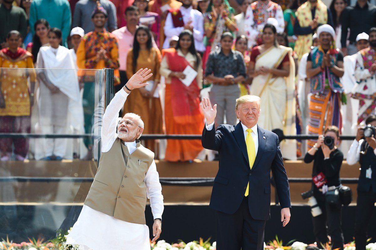 US President Donald Trump (R) and India's Prime Minister Narendra Modi wave at the crowd during 'Namaste Trump' rally at Sardar Patel Stadium in Motera, on the outskirts of Ahmedabad, on February 24, 2020. (Photo by Money SHARMA / AFP) (Photo by MONEY SHARMA/AFP via Getty Images)