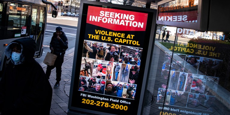 A billboard on a bus stop advertises a message from the Federal Bureau of Investigation seeking information related to violence at the U.S. Capitol, on January 9, 2021 in Washington, DC.