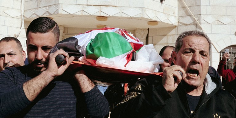 Palestinian relatives mourn during the funeral of Omar Abdalmajeed Assad, 78, who was found dead after being detained and handcuffed during an Israeli raid, in Jiljilya village in the Israeli-occupied West Bank, on January 13, 2022. (Photo by JAAFAR ASHTIYEH / AFP) (Photo by JAAFAR ASHTIYEH/AFP via Getty Images)