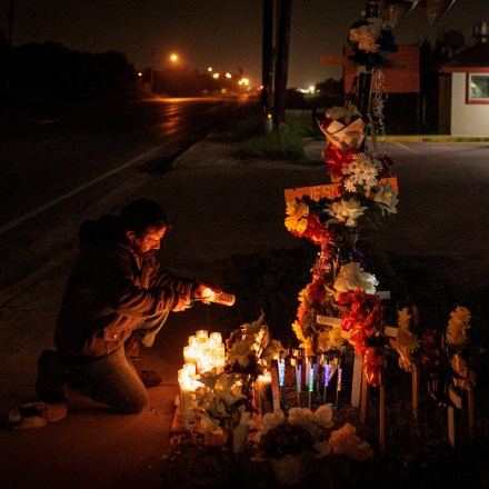 BROWNSVILLE, TEXAS - MAY 7: A man lights a candle at a memorial for eight migrants that were run over and killed today waiting at a bus stop on May 7, 2023 in Brownsville, Texas. George Alvarez was arraigned on eight counts of manslaughter and 10 counts of aggravated assault with a deadly weapon after the SUV he was driving ran a red light,  lost control and flipped on its side, striking 18 people, according to published reports.  (Photo by Michael Gonzalez/Getty Images)