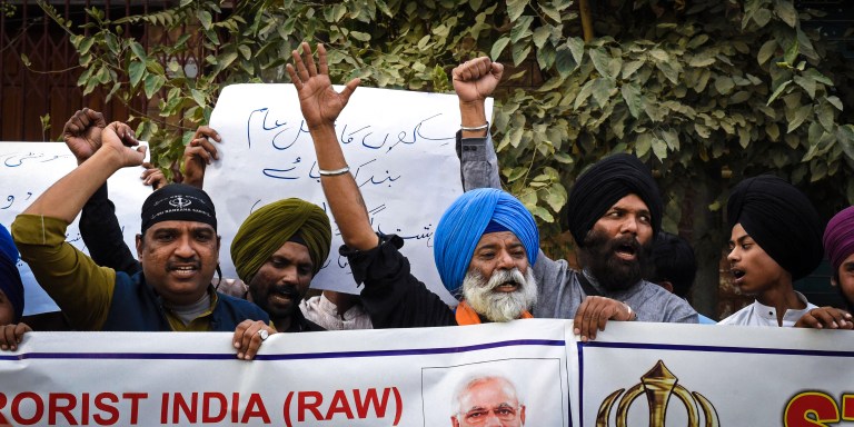 Members of Pakistan's Sikh community shout slogans as they hold banners during a protest in Quetta on September 23, 2023, to condemn the killing of a Sikh separatist Hardeep Singh Nijjar in Canada. India's historic adversary Pakistan said on September 21, that Western nations had failed to see the "reality" of New Delhi's right-wing leadership after Canada alleged Indian involvement in a killing. Canada expelled an Indian diplomat, prompting a tit-for-tat reaction, after concluding that Indian agents played a role in the June killing near Vancouver of a Sikh separatist, Hardeep Singh Nijjar. (Photo by Banaras KHAN / AFP) (Photo by BANARAS KHAN/AFP via Getty Images)