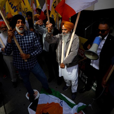 People stomp on an Indian flag and a cutout of Indian prime minister Narendra Modi during a Sikh rally outside the Indian consulate in Toronto to raise awareness for the Indian government's alleged involvement in the killing of Sikh separatist Hardeep Singh Nijjar in British Columbia on September 25, 2023. Prime Minister Justin Trudeau's assertion on September 17, 2023 that agents linked to New Delhi may have been responsible for the June 18 murder of Hardeep Singh Nijjar, a Canadian citizen, sent shockwaves through both countries, prompting the reciprocal expulsion of diplomats. (Photo by Cole BURSTON / AFP) (Photo by COLE BURSTON/AFP via Getty Images)
