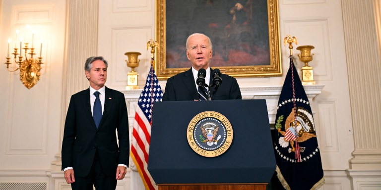 US President Joe Biden, with Secretary of State Antony Blinken, addresses the attacks in Israel from the State Dining Room of the White House in Washington, DC, on October 7, 2023. Palestinian militant group Hamas launched a surprise large-scale attack against Israel Saturday, firing thousands of rockets from Gaza and sending fighters to kill or abduct people as Israel retaliated with devastating air strikes. (Photo by Jim WATSON / AFP) (Photo by JIM WATSON/AFP via Getty Images)