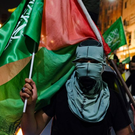 Supporters of the Fatah and Hamas movments lift group and Palestinian flags as they march in Hebron city in the occupied West Bank on October 11, 2023, to protest the Israeli bombardment of the Gaza Strip. Israel kept up its bombardment of Hamas targets in the Gaza Strip on October 11, as Prime Minister Benjamin Netanyahu and a political rival announced an emergency government for the duration of the conflict that has killed thousands. (Photo by HAZEM BADER / AFP) (Photo by HAZEM BADER/AFP via Getty Images)