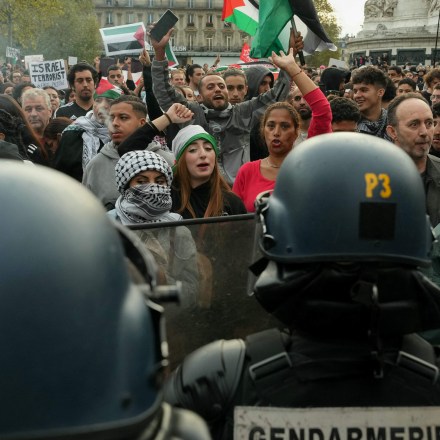 Protestors face French Gendarmes as they gather at Place de la Republique for an unauthorized demonstration in support of Palestinians in Paris, on October 12, 2023. France on October 12, 2023 said it was banning all pro-Palestinian demonstrations after the attack on Israel by Hamas, on the grounds such protests threaten to public order. Interior Minister Gerald Darmanin said that the demonstrations "are likely to generate disturbances to public order" adding that organisers should face arrest. Fighting between Israel and Hamas has entered a sixth day following the assault on Israel by the Palestinian militant group on October 7, which has claimed thousands of lives on both sides. (Photo by Dimitar DILKOFF / AFP) (Photo by DIMITAR DILKOFF/AFP via Getty Images)