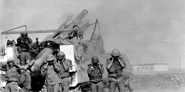 Israeli soldiers plug their ears as they fire shells in October 1973 at the Syrian front lines on the Syrian Golan Heights, two weeks after the beginning of the 1973 ArabIsraeli War. On October 6, 1973, on the Jewish holiday of Yom Kippur, an Arab military coalition led by Egypt and Syria launched a simultaneous surprise attack in the Sinai Peninsula and the Golan Heights, territories occupied by Israel since the 1967 ArabIsraeli War. This war provoked the oil shock of 1973 and led to the opening of peace negotiations between Israel and Egypt, concluded by the Camp David agreement in 1978. (Photo by GABRIEL DUVAL / AFP) (Photo by GABRIEL DUVAL/AFP via Getty Images)