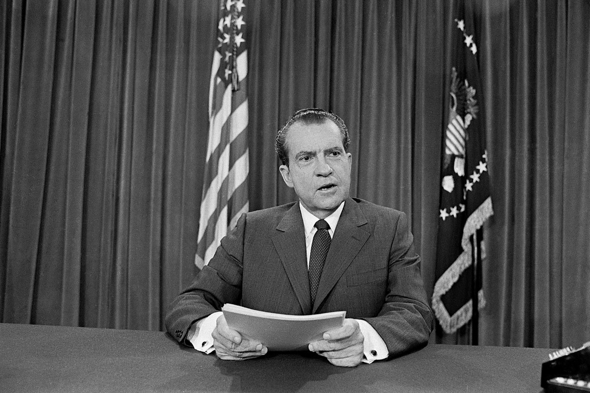 (Original Caption) 4/30/1970-Washington, DC-In a TV speech to the Nation from the White House, President Nixon announced that several thousand American ground troops have entered Cambodia to wipe out Communist headquarters for all military operations against South Vietnam. The president is shown here seated at his desk during the address.