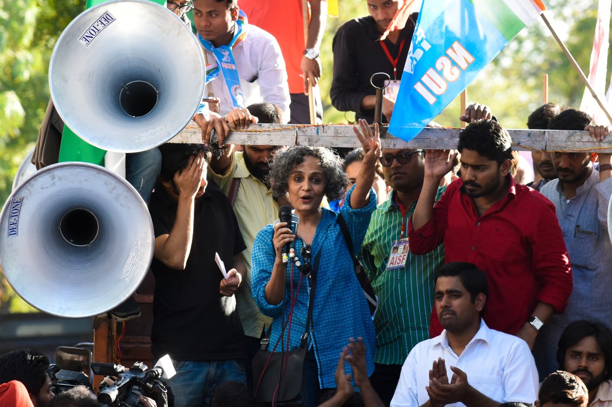 NEW DELHI, INDIA - MARCH 15: Writer and activist Arundhati Roy speaks to gathering after the march from Mandi House to Parliament to demand the release of Umar Khalid and Anirban Bhattacharya on March 15, 2016 in New Delhi, India. The JNU or Jawaharlal Nehru University has sent notice to 21 students including Kanhaiya Kumar over a controversial February 9 event in support of Parliament attack convict Afzal Guru, in which anti-India slogans were raised. Kanhaiya Kumar, charged with sedition for his alleged role in the event, was released from jail earlier this month after three weeks in jail. Two others, Umar Khalid and Anirban Bhattacharya, are still in jail. (Photo by Vipin Kumar/Hindustan Times via Getty Images)