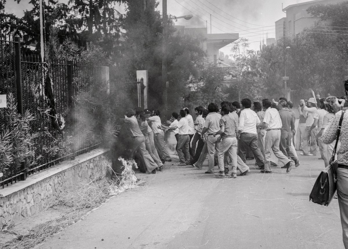 (Original Caption) Greek Cyprist demonstrators storm the gate of the U. S. embassy here, as police fire tear gas in efforts to keep them out. They failed, and gunmen killed U. S. Ambassador Rodger B. Davies and a secretary.