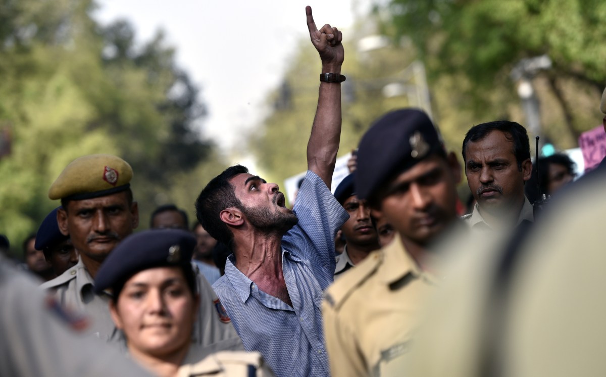 NEW DELHI, INDIA - MARCH 30: JNU student Umar Khalid under heavy police protection with students of JNU and others during the peace march for the justice of Rohith Vermula from Mandi House to Jantar Mantar  on March 30, 2016 in New Delhi, India. 25 students and two faculty members of Hyderabad Central University were arrested in connection with incidents of vandalism at the VC's lodge and stone pelting on police personnel on March 22. (Photo by Arun Sharma/Hindustan Times via Getty Images)