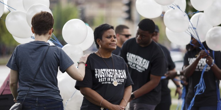 Nerina Joseph looks off as balloons are distributed during a memorial vigil for her son Jeancarlo Alfonso Jimenez Joseph who hanged himself while in ICE custody at the Stewart Detention Center. Attendees flew into Kansas City, MO from all over to be present at the vigil, held on the one year anniversary of his death.