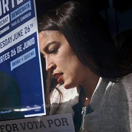 Congressional candidate Alexandria Ocasio-Cortez, left, paste posters in Bronx,  New York, Saturday, April 21, 2018. (Photo: Andres Kudacki)