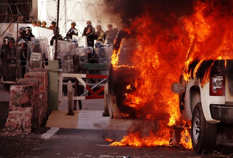 Image #: 34219615    (150113) -- GUERRERO, Jan. 13, 2015 (Xinhua) -- Flames emanate from a vehicle during a protest in front of the 35th Military Zone in Chilpancingo, capital of Guerrero State, Mexico, on Jan 12, 2015. According to local press, the parents of missing students, with support of the memebers of the State Coordinator of Education Workers of Guerrero (CETEG in Spanish), burnt an official vehicle in front of the main door of the 50th Infantry Battalion of the 35th Military Zone, demanding the presentation of results in the search for 43 missing students abducted in Guerrero State in September 2014. (Xinhua/Edgar de Jesus Espinoza) (dzl)       XINHUA /LANDOV