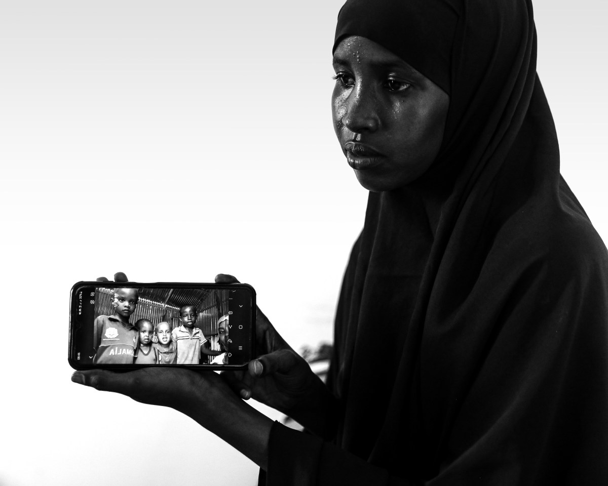 Qaali Dahir Mohamed, 18 yrs old Luley's full-sister, shows a selfie picture of her with her nephew Mohamed Amin (right) and other children through her mobile in Mogadishu, Somalia, Wednesday, May. 10, 2023. ( Omar Faruk for The Intercept)